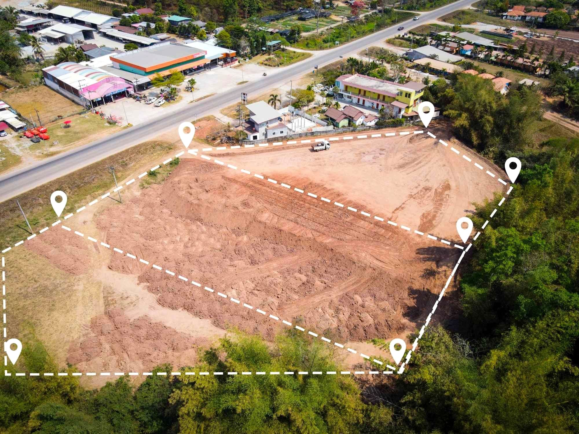 Aerial view of the same site levelled and marked out, its boundary pinned corner to corner